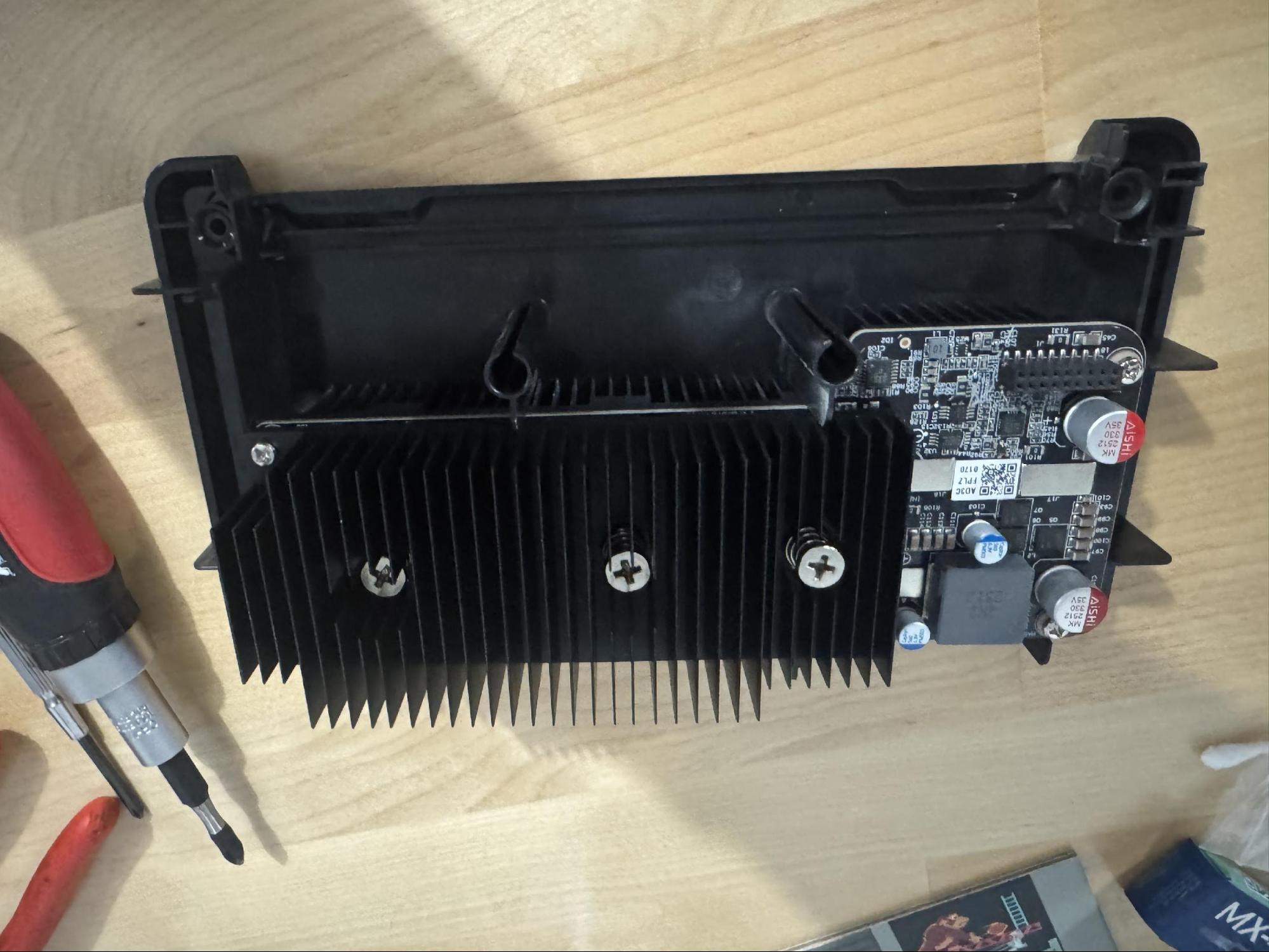 Heatsink reinstalled with spring-loaded screws torqued down and plastic guide tubes visible.