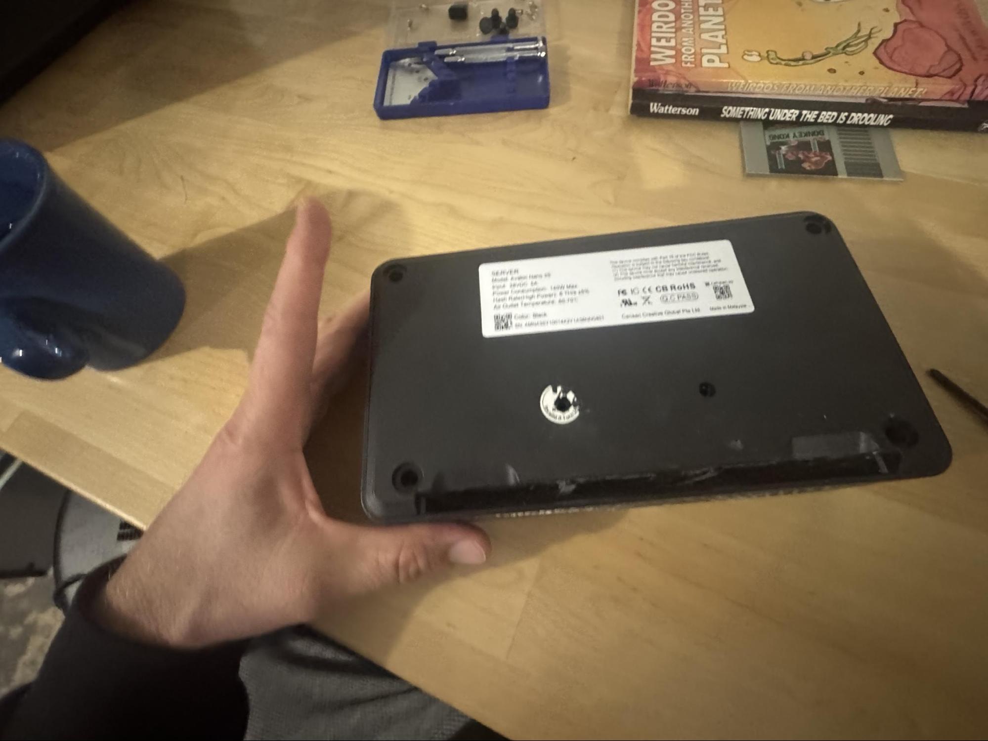 Bottom of the Nano3s unit showing six Phillips screws and rubber feet at the corners.