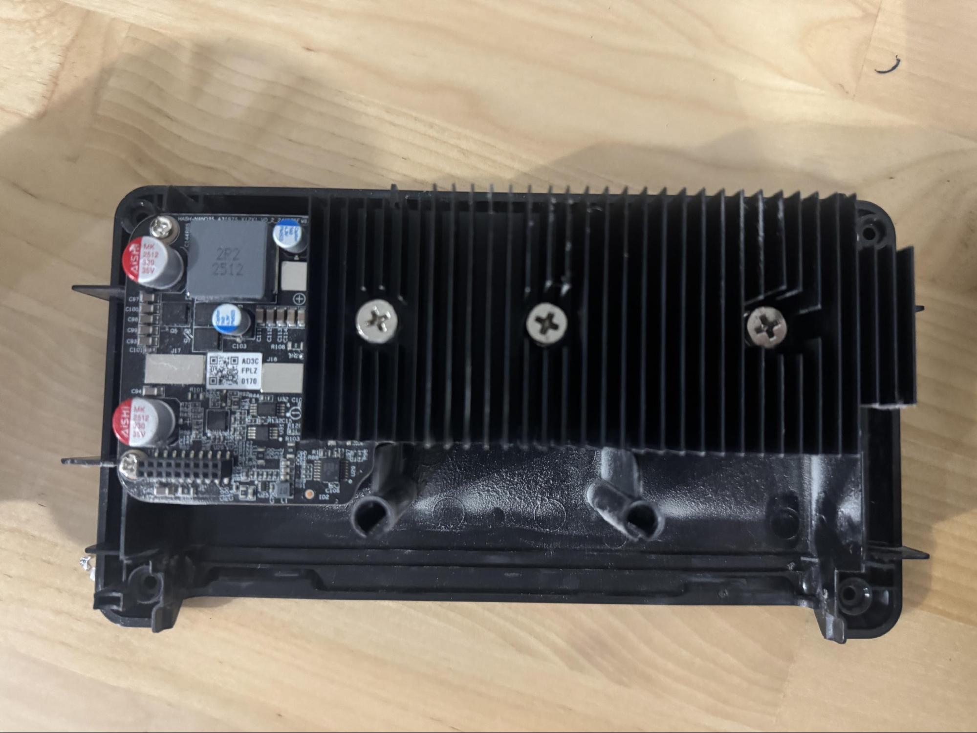 Hashboard with heatsink mounted showing spring-loaded screws and 18-pin connector.
