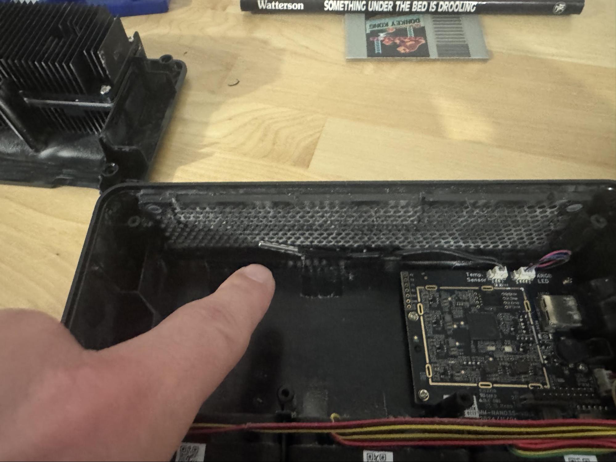 Dust accumulation around the hexagonal mesh intake on top of the unit.